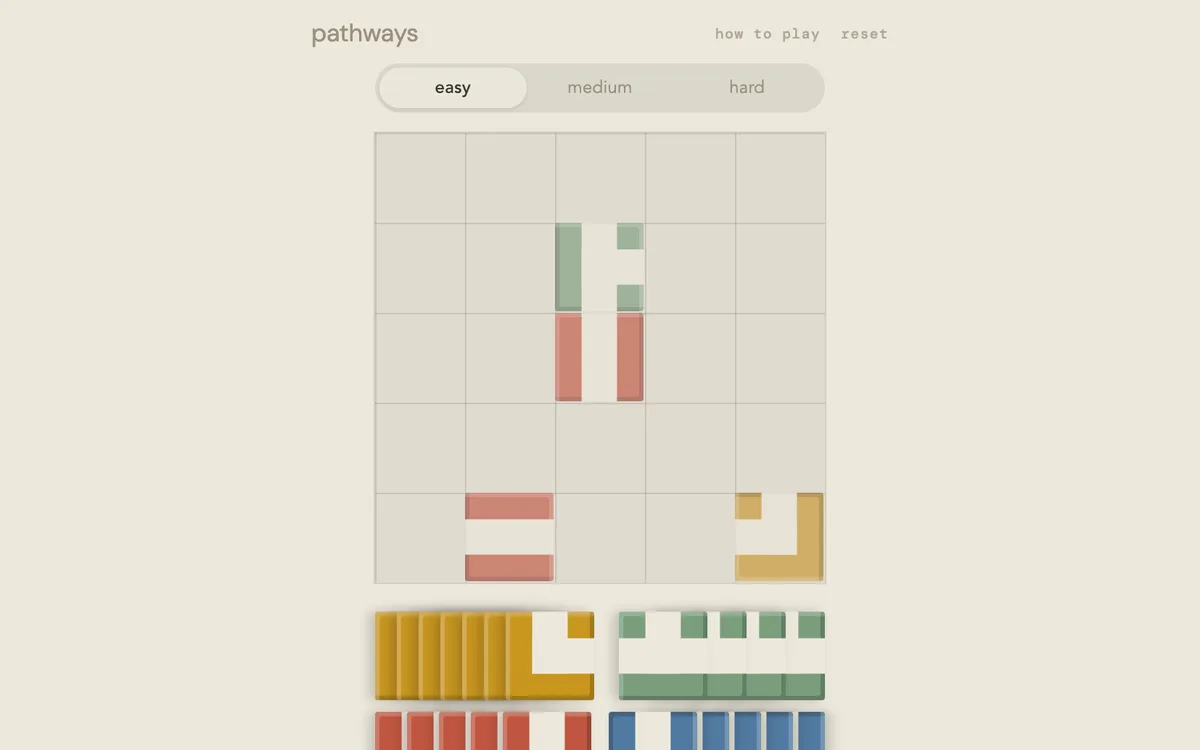 Pathways easy board with a few tiles placed and a tray of unused path pieces